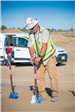 Firestone PD Groundbreaking picture of FCI worker putting in shovel in the ground