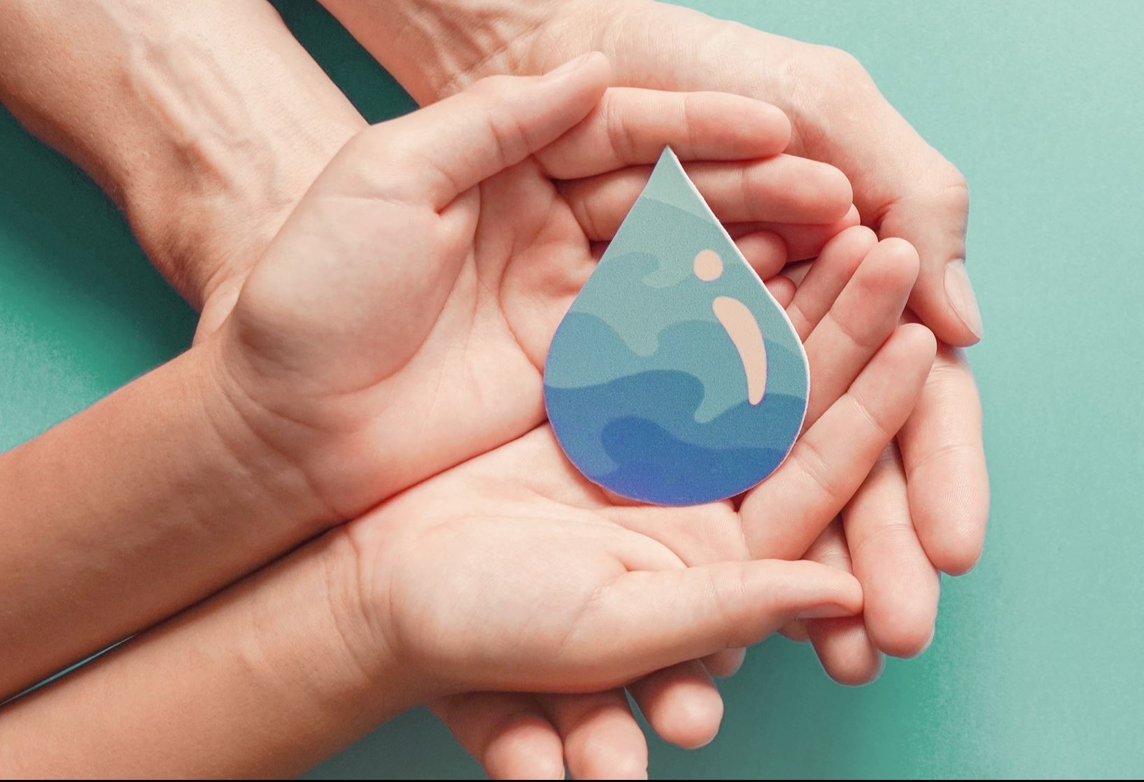 Hand holding water drop